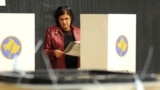 KOSOVO -- A woman prepares to cast her vote at a polling station in Gracanica, near Pristina, Kosovo, October 6, 2019, 