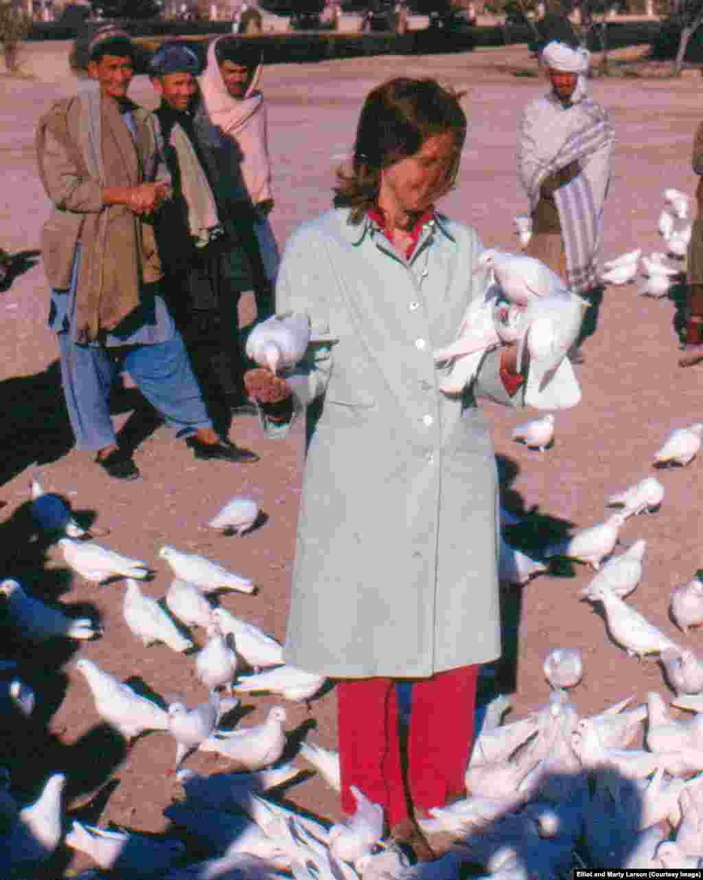 Marty Larson feeds doves at the Blue Mosque in Mazar-e Sharif.&nbsp;