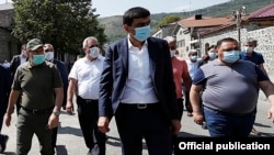 Armenia -- Armenian Prime Minister Nikol Pashinian (L), Goris Mayor Arush Arushanian (C) and other officials walk through the center of the town, September 12, 2020. 