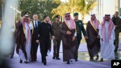 Ukrainian President Volodymyr Zelenskyy (second left) is welcomed by Saudi officials upon his arrival in Riyadh on March 10. 