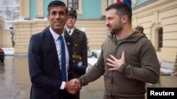 British Prime Minister Rishi Sunak (left) shakes hands with Ukrainian President Volodymyr Zelenskiy during his visit to Kyiv on November 19.