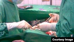 Tajik doctor participating in surgery of Afghan boy in Takhar province