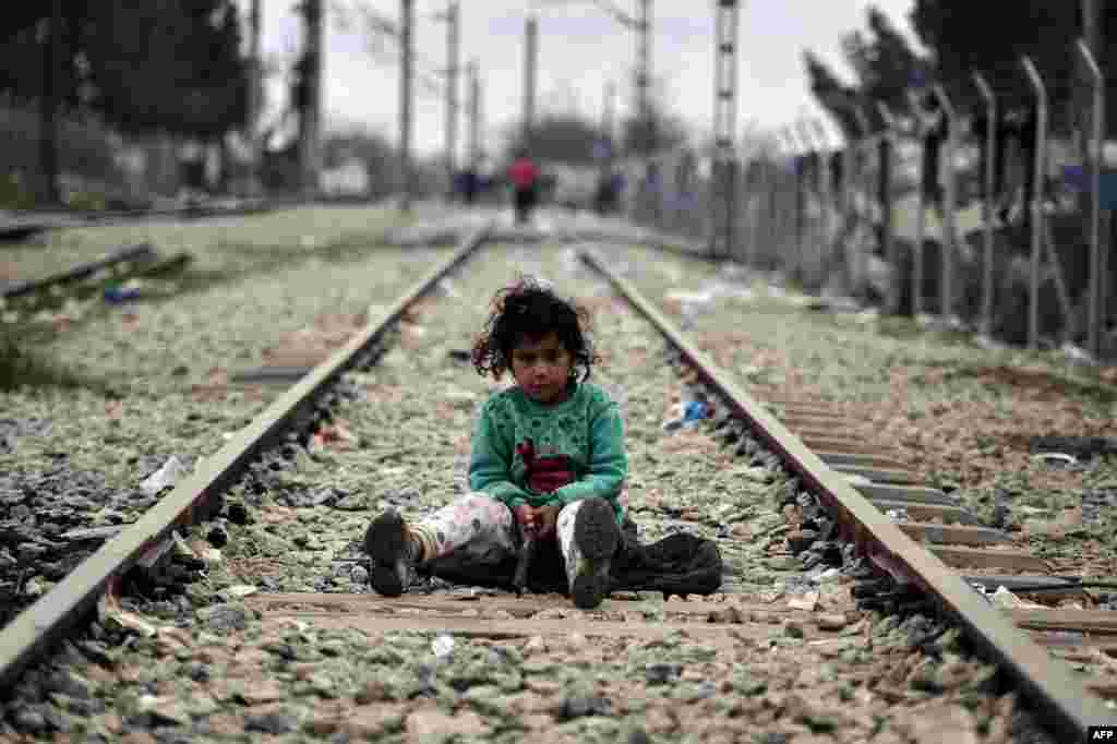 A child plays on a rail track at the Greek-Macedonian border near the Greek village of Idomeni where thousands of migrants and refugees are stranded. (AFP/Louisa Goulimaki)