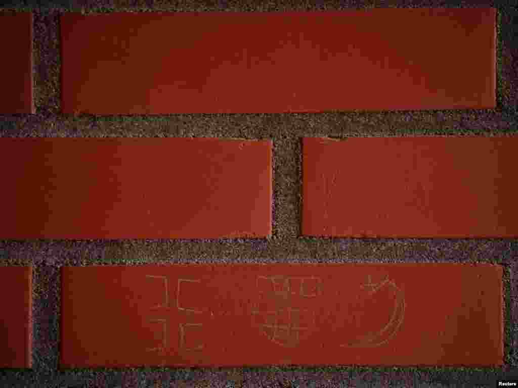 Serb, Croat, and Muslim signs are seen on the wall of a balcony at the Detention Unit.