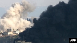 Smoke from Israeli strikes billows in Gaza City on January 9.