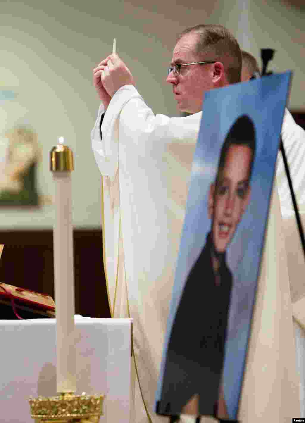 Father Sean Connor conducts a mass to celebrate the young life of Martin Richard of Dorchester in Boston, Massachusetts, on June 9, 2013.&nbsp;