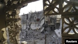 Buildings damaged by what activists said was shelling by forces loyal to Syria's President Bashar al-Assad in Homs on April 7