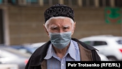 Kazakhstan. A man in a protective mask is walking down the street. Almaty, may 9, 2020