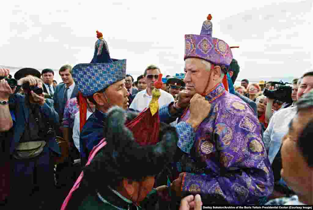 Yeltsin has traditional clothing adjusted by locals while on a trip to the southern Russian city of Kyzyl, in June 1994.&nbsp;