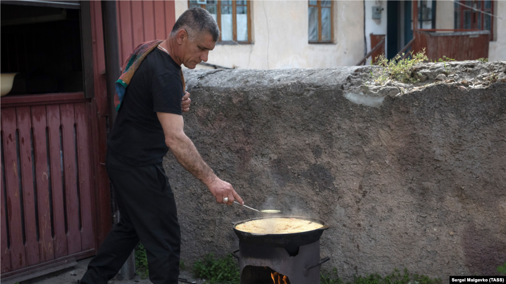 ​Yerli sakin Eski şeerde pilâv pişire