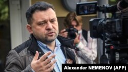 Sergei Boiko, the head of Aleksei Navalny's Novosibirsk headquarters and a City Council candidate, talks to the media in front of a polling station in Novosibirsk on September 13, 2020. 