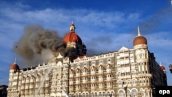 Firefighters try to douse a fire at the Taj hotel in Mumbai amid a deadly attack in November 2008.