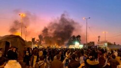 Smoke rises from the sites of anti-government protests in Najaf, February 5, 2020