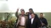 FILE - Iranian scientist Shahram Amiri, surrounded by Iranian officials, flashes the victory sign as he arrives at the Imam Khomeini airport in Tehran .July 15, 2010