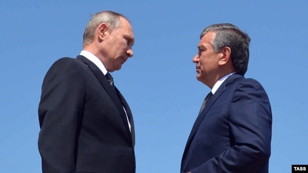 Then-Uzbek Prime Minister Shavkat Mirziyaev (right) speaks with Russian President Vladimir Putin after laying flowers at the grave of late Uzbek President Islam Karimov in Samarkand on September 6.