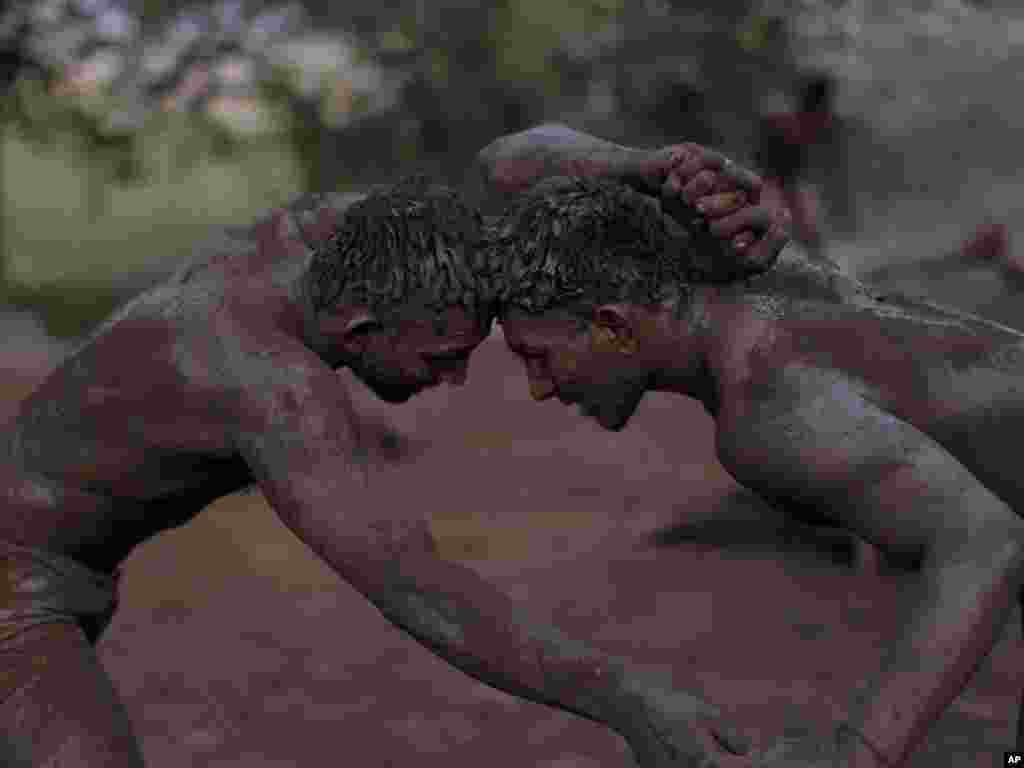 Pakistani Kushti wrestlers fight as part of their daily training in Lahore, Pakistan, on June 22.Photo by Muhammed Muheisen for AP