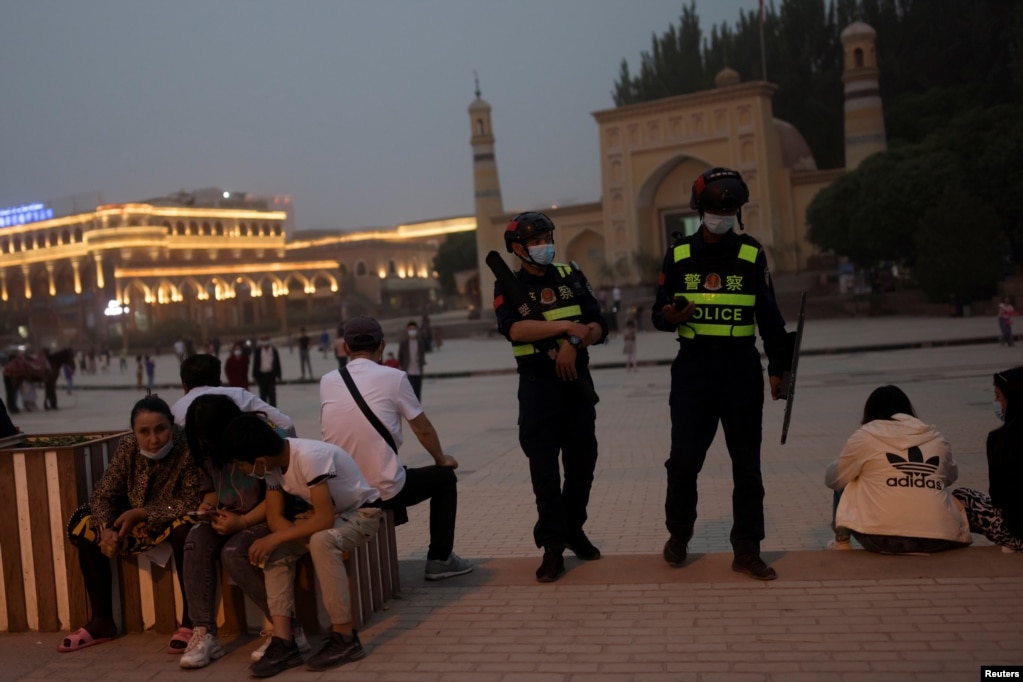 Police officers patrol the square in front of Id Kah Mosque in Kashgar, Xinjiang, on May 3.