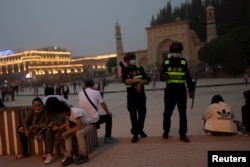 Police officers patrol the square in front of Id Kah Mosque in Kashgar, Xinjiang, on May 3.