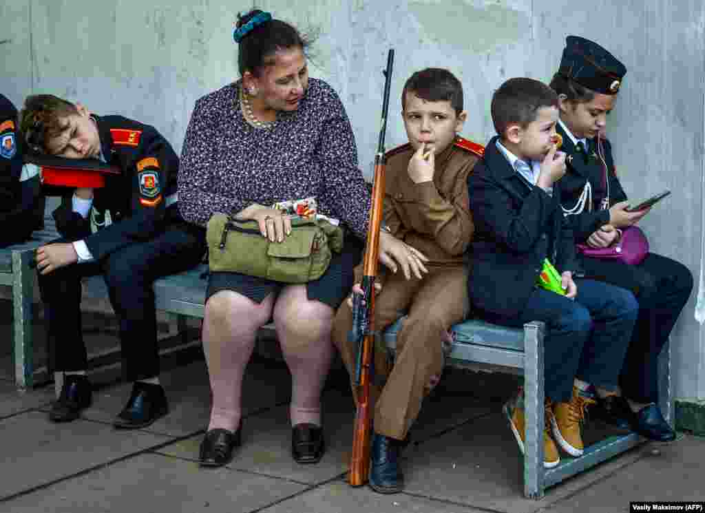 A mother speaks with her son before the beginning of the cadet movement members parade at Poklonnaya hill in Moscow on May 6. (AFP/Vasily Maksimov)