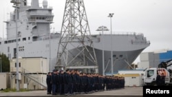 Russian sailors gather in front of the Mistral-class helicopter carrier "Vladivostok" at the STX Les Chantiers de l'Atlantique shipyard site in Saint-Nazaire on December 17.