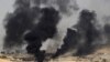 IRAQ -- Smoke billows from the village of al-Ayadieh, near Qubuq, north of Tal Afar, as Iraqi forces advance during the ongoing operation to retake the area from the Islamic State (IS) group, August 28, 2017