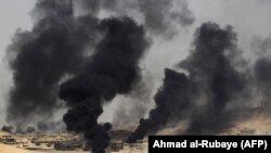 IRAQ -- Smoke billows from the village of al-Ayadieh, near Qubuq, north of Tal Afar, as Iraqi forces advance during the ongoing operation to retake the area from the Islamic State (IS) group, August 28, 2017