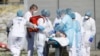 FRANCE -- A victim of the Covid-19 virus is evacuated from the Mulhouse civil hospital, March 23, 2020