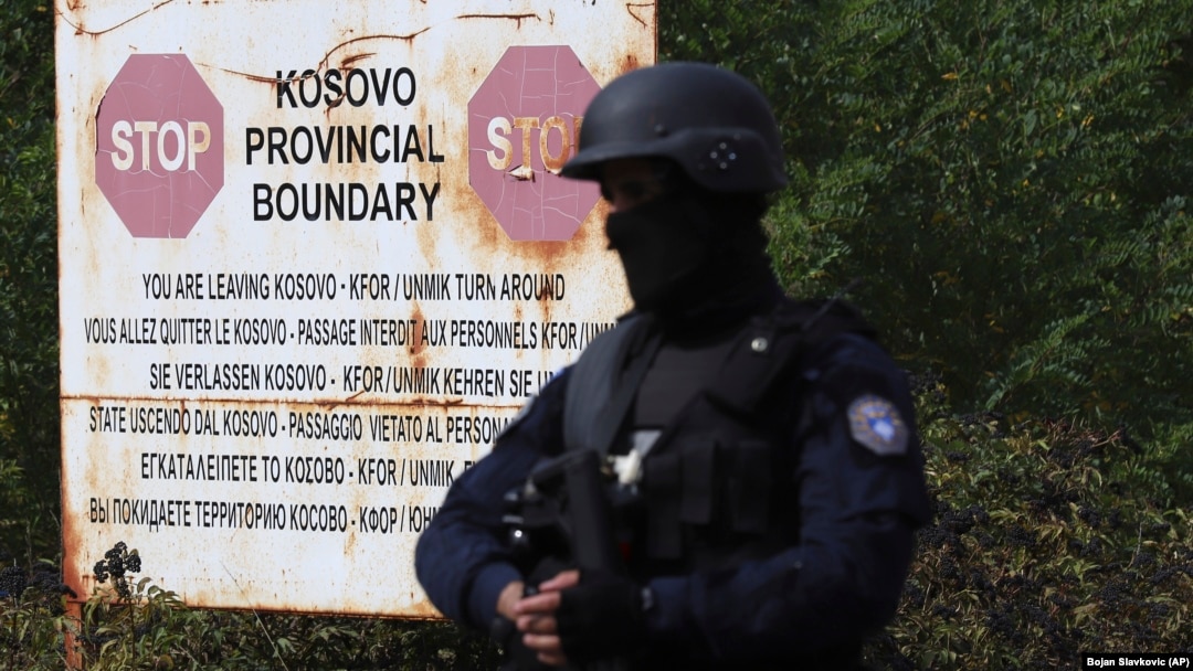 With rising tensions, a Kosovo police officer stands guard at the border crossing of Jarinje on September 20.