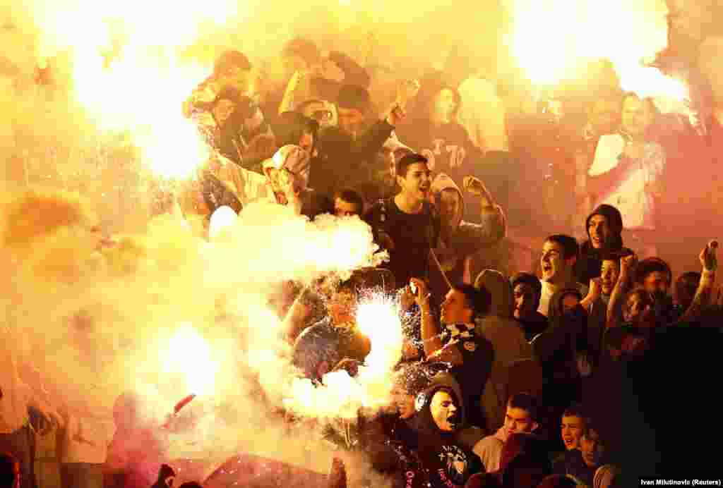 Partizan fans light flares during a match against Red Star in March 2012.Vuk Cvijic, a journalist with Serbian news magazine Radar, told RFE/RL that the main determinant for which team Belgraders support is family legacy. “Some families have grandparents who are Red Star [supporters] some are Partizan,” he says.