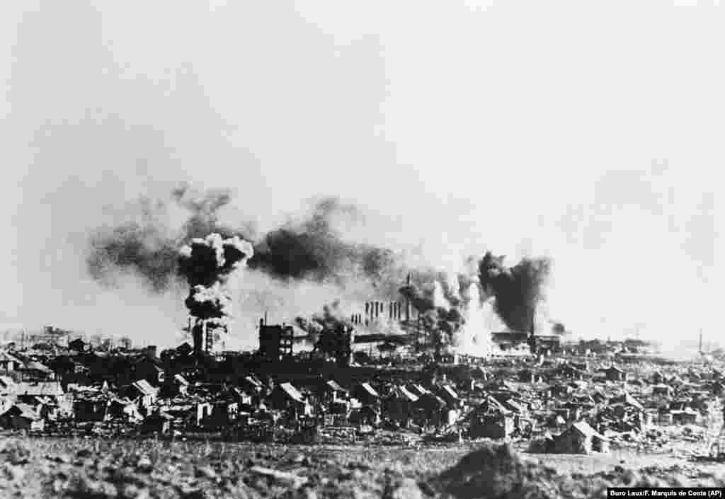 Smoke billows from an industrial area of Stalingrad following an attack by German Stuka dive bombers on November 24, 1942, according to a caption passed through German government censors. (Buro Laux/F. Marquis de Costa&nbsp;via AP)