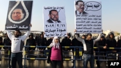 Anti-Mubarak protesters held up placards calling for his execution during the former president's trial in the outskirts of Cairo on January 2.