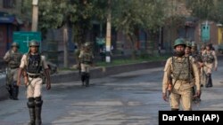 Indian paramilitary soldiers patrol during curfew in Srinagar on August 7.
