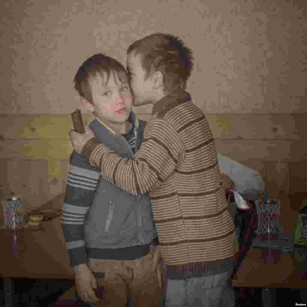 sa Sjostrom, a Swedish photographer working for Moment Agency, won Second Prize in the Daily Life Category, Singles, with this image of twin brothers Igor and Arthur handing out chocolates to their classmates to celebrate their ninth birthday in Baroncea, Moldova.