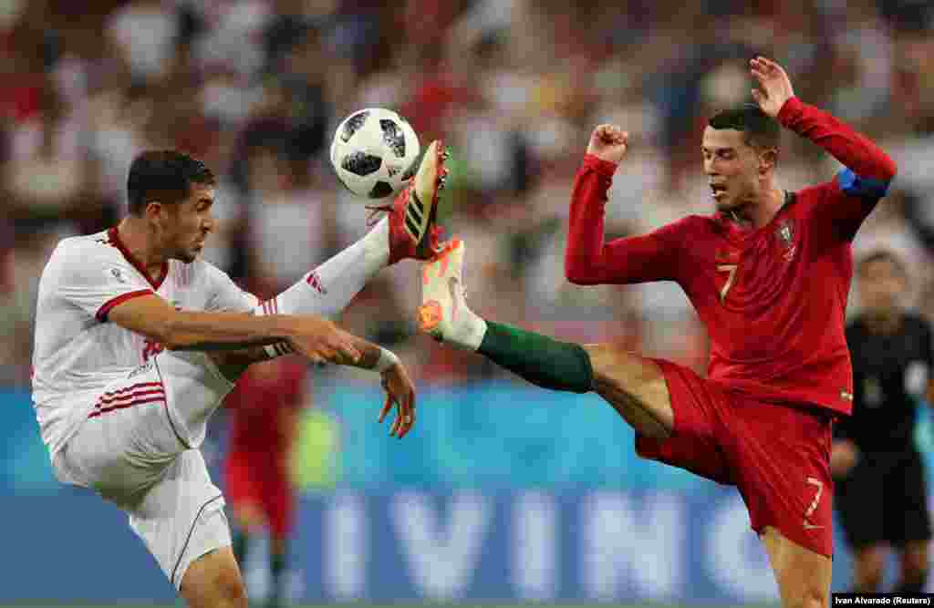 Iran&#39;s Majid Hosseini (left) competes for the ball with Portugal&#39;s Cristiano Ronaldo in their countries&#39; World Cup group game in Saransk, Russia, on June 25. (Reuters/Ivan Alvarado)