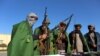 FILE: Former Taliban members surrender their weapons during a ceremony marking their reconciliation with the government in Herat on November 15.