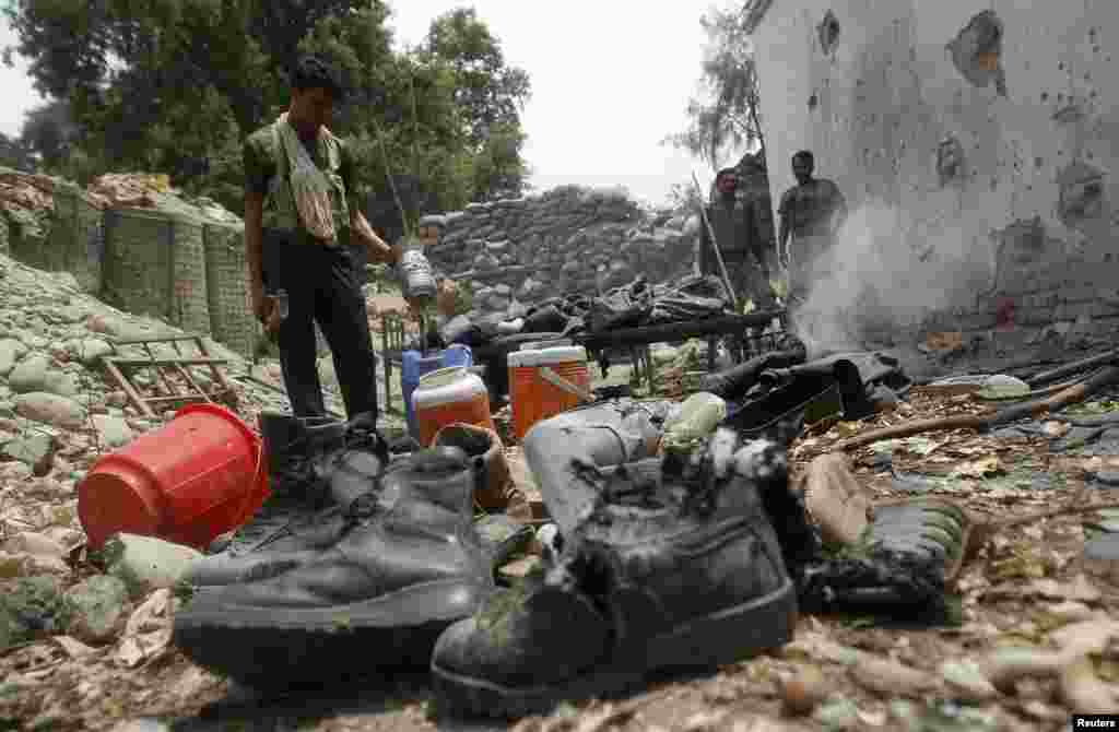 Afghan police inspect a police checkpoint that was mistakenly attacked by NATO aircraft during a clash between Afghan special forces and a group of Taliban fighters in Nangarhar Province. Five Afghan police officers died in the incident. (Reuters/ Parwiz)