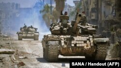 A handout picture released by the official Syrian Arab News Agency on May 14 shows government forces head towards militant positions in the Hajar al-Aswad district on the southern outskirts of Damascus.