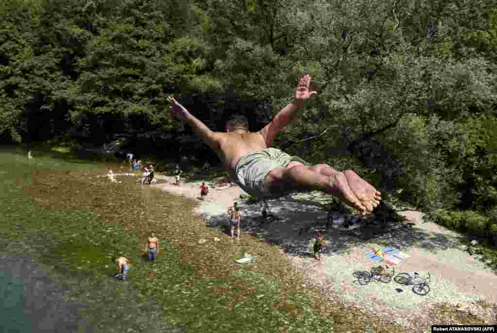A young man dives in the Treska River near Skopje, Macedonia, on August 8 as temperatures soared to 37 degrees Celsius. (AFP/Robert Atanasovski)