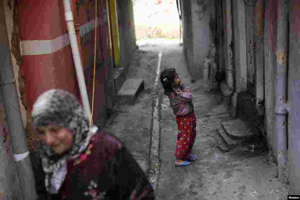 A girl laughs in a street next to frontline positions of Iraqi Federal Police fighting the Islamic State in Mosul on April 2. (Reuters/Andres Martinez Casares)