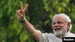 India -- Hindu nationalist Narendra Modi, the prime ministerial candidate for India's main opposition Bharatiya Janata Party (BJP), gestures during a public meeting in Vadodra, in the western Indian state of Gujarat May 16, 2014 