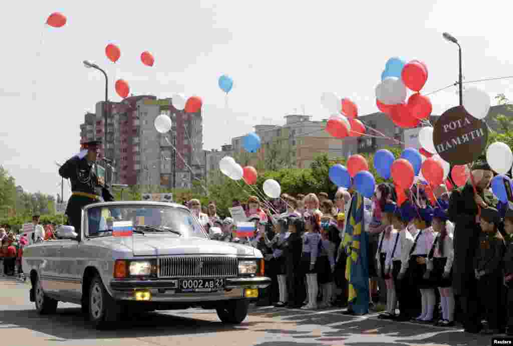 Children line up to greet the parade commander.