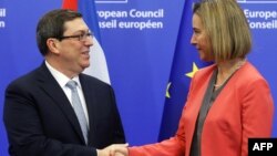 The EU's foreign policy chief, Federica Mogherini (right) welcomes Cuban Foreign Minister Bruno Rodriguez Parrilla at the start of an EU-Cuba political dialogue in Brussels on December 12.