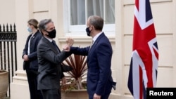 British Foreign Secretary Dominic Raab (right) greets U.S. Secretary of State Antony Blinken at Carlton Gardens for talks in London on May 3.