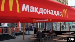 Russia -- People sit on the terrace of a closed McDonald's restaurant, the first to be opened in the Soviet Union in 1990, in Moscow, August 21, 2014