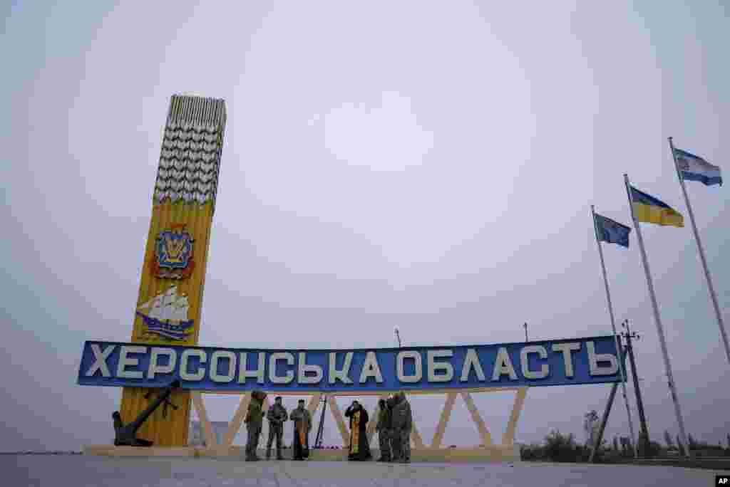 A Ukrainian military chaplain reads a prayer to servicemen in Kherson on the second anniversary of the city&#39;s liberation from Russian occupation.&nbsp;