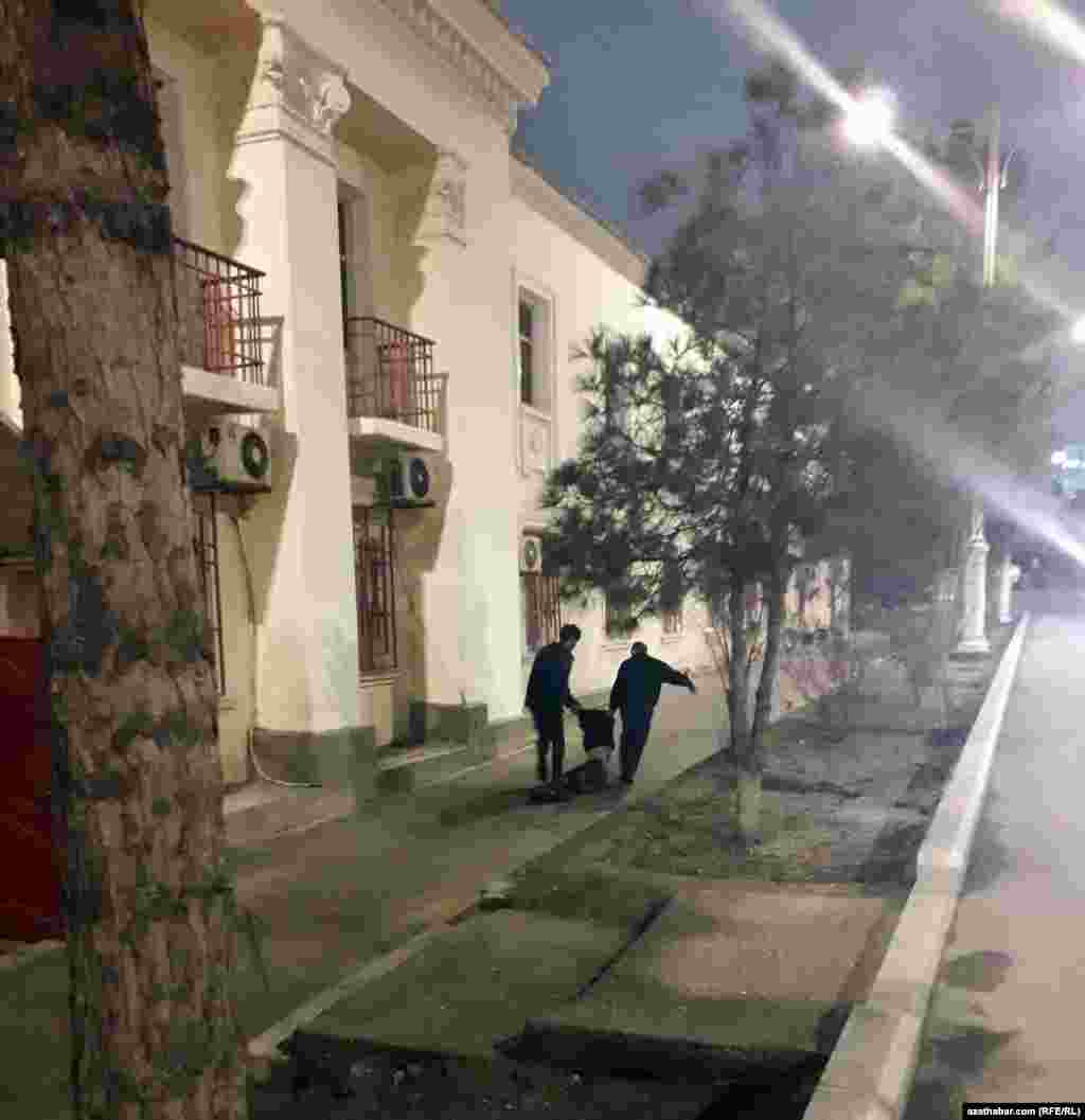 Polisiýa işgärleri ýolda bir adamy tussag edýär.