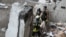 Rescue workers deal with the aftermath of a Russian drone attack on the Ukrainian city of Sumy on January 30. 