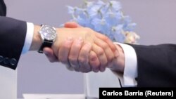 U.S. President Donald Trump (right) shakes hands with Russian President Vladimir Putin at the G20 summit in Hamburg on July 7, 2017.