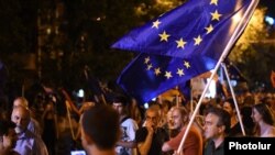 Armenia - Paruyr Hayrikian (L) and his supporters carry European Union flags on Marshal Bagramian Avenue, Yerevan, 2Jul2015.