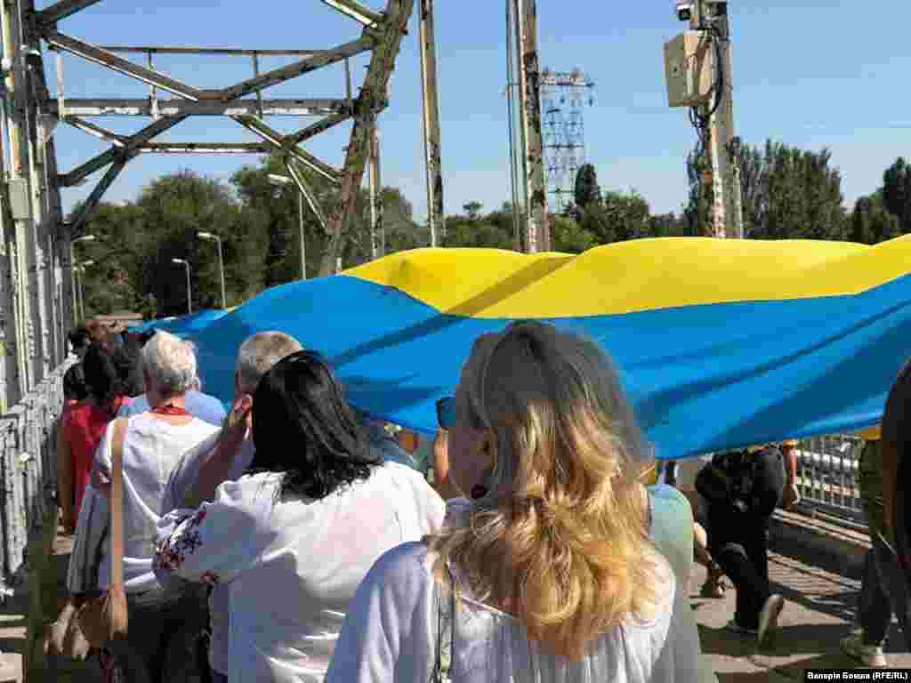 Далі хода з прапором України пройшла через пішоходний міст у Дніпрі